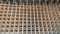 Rusty steel welded wire mesh background. Reinforcing frame of the base plate. Building materials warehouse for construction of fou