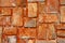 Rusty stone wall in orange and grey colors. Brickwork closeup photo for background. Rustic brick masonry.