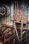 Rusty tools leaning against corrugated metal wall