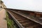 Rusty tracks of a train transport path of a lonely railway where nobody is there