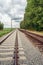 Rusty train tracks with overhead lines in the Netherlands