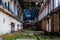 Rusty turbine generator. Abandoned destroyed by war and overgrown by plants and moss machinery of Tkvarcheli Tquarchal power plant