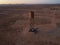 Rusty water tank in an arid desert environment, surrounded by barren terrain