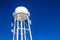 Rusty Water Tower Tank Against Blue Sky Background