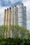 Rusty weatherworn old smokestacks against cloudy sky