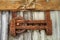 Rusty wheel on a corrugated iron building