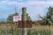 Rusty wire fence with old No Trespassing and Posted signs at a private property