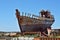 Rusty wooden and metal shipwreck in the Icelandic dry dock in the Akranes town as a symbol of corrosion and decay