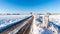 Rutted road covered by ice between snowy fields