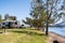 RV caravans camping at the caravan park on the lake with mountains on the horizon. Camping vacation travel concept