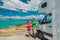 RV motorhome camper van road trip on New Zealand. Young couple on travel vacation adventure. Two tourists looking at