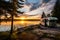 RV recreation vehicle parked next to lake during summer time