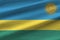 Rwanda flag with big folds waving close up under the studio light indoors. The official symbols and colors in banner