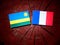 Rwanda flag with French flag on a tree stump isolated