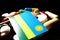 Rwandan flag with lot of medical pills isolated on black background