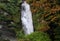 Rychenbachfall waterfall and autumn yellowed trees near Meiringen, Switzerland