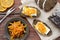 Rye bread with butter and homemade orange confiture on rusted wooden table