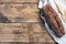 Rye bread with cereals, a fresh loaf of grain baguette on a wooden background. copy space