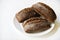 Rye bread from a hypermarket on a white plate. Delicious and beautiful bread macrophoto