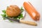 Rye bread, parsley in plate, sausage, kitchen knife on table