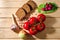 Rye bread, radish, tomatoes, onions, greens, garlic herb and spices on wooden background