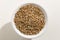 Rye cereal grain. Top view of grains in a bowl. White background