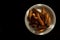 Rye croutons on a white plate isolated on a black background.