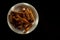 Rye croutons on a white plate isolated on a black background.