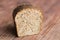 Rye grey bread with spices on wooden background