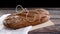 Rye organic healthy bread on cutting board and cloth on wooden table
