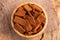 Rye salted crackers in wooden bowl on burlap napkin