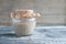 Rye sourdough on whole grain flour in glass jar on table, yeast-free leaven starter for healthy organic rustic bread