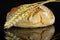 Rye wheat bread isolated on black glass