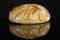 Rye wheat bread isolated on black glass