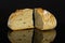 Rye wheat bread isolated on black glass