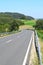s-curve of an Eifel road through farmland