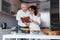 That`s mine secret book of recipes. Man and his wife in white shirt preparing food on the kitchen using vegetables