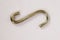 S-shaped metal hook on white background