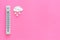 It`s snow weather concept. Air temperature. Termometer near snow cloud on pink background top view copy space