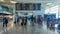 Sa Carneiro airport interior view, departures and arrivals information board, people walking with suitcases and bags and staying