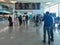 Sa Carneiro airport interior view, departures and arrivals information board, people walking with suitcases and bags and staying