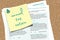SA100 tax form with note anuual tax return text pinned to cork