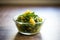 saag aloo in a glass bowl with backlighting