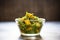 saag aloo in a glass bowl with backlighting