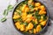 Saag Aloo Indian style spinach and potatoes curry in a bowl closeup. Horizontal top view