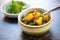 saag aloo paired with mango chutney in a small bowl