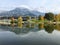 Saalfelden ritzensee with still reflecting water  mountain with clouded tops