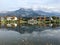 Saalfelden ritzensee with still reflecting water and mountain with clouded tops