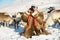 Saami men looks for reindeers with binocular in deep snow winter in Tromso region, Northern Norway.