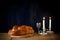 Sabbath image. challah bread and candelas on wooden table